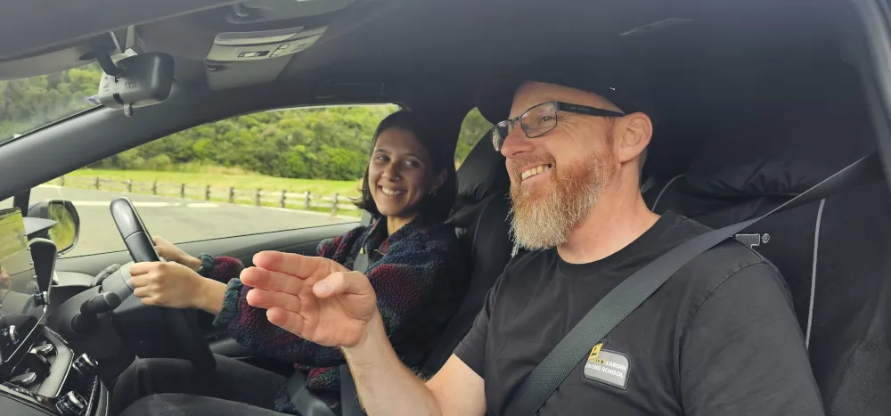 Marcel instructing a student driver in the car.